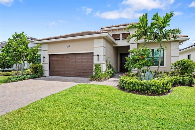 view of front of home with a garage and a front lawn