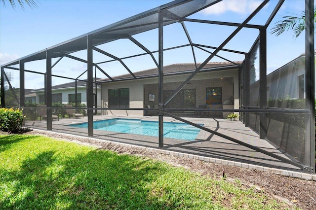 view of pool featuring glass enclosure and a patio area