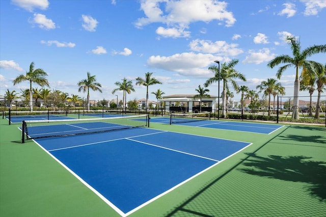 view of tennis court with basketball hoop