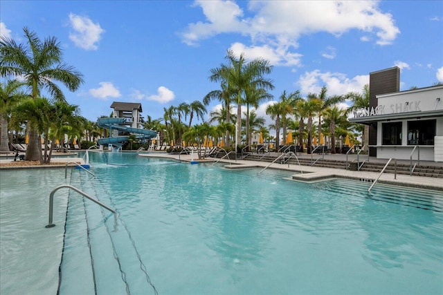 view of swimming pool with a water slide