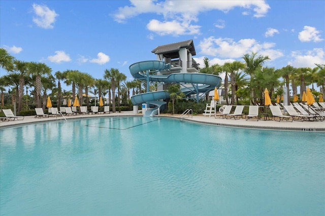 view of pool with a patio and a water slide