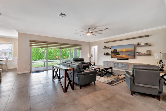 tiled living room with crown molding, a wealth of natural light, and ceiling fan