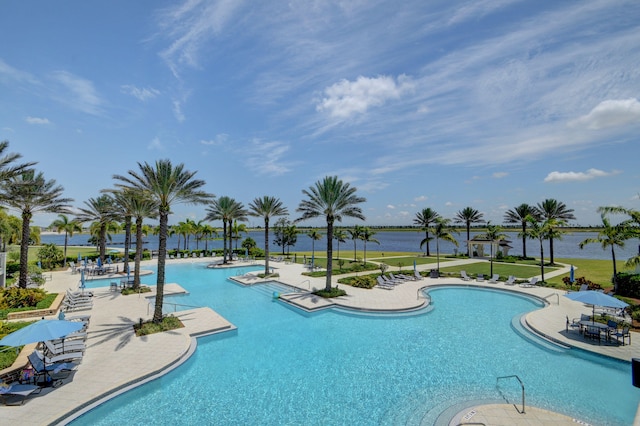 view of swimming pool with a patio and a water view