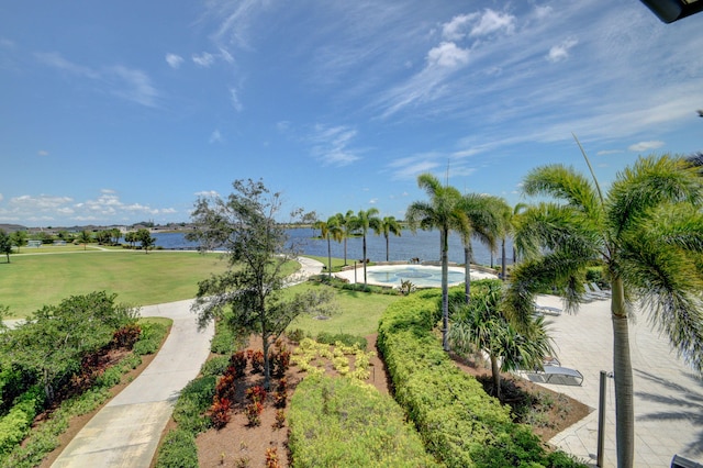 view of community featuring a water view and a yard