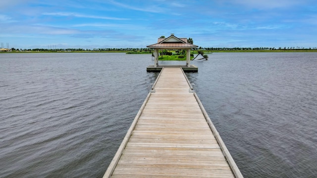 view of dock with a water view and a gazebo