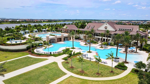 pool with a patio area and a yard