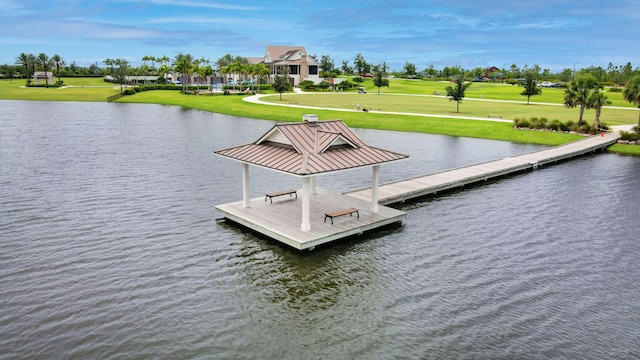 dock area with a water view and a lawn