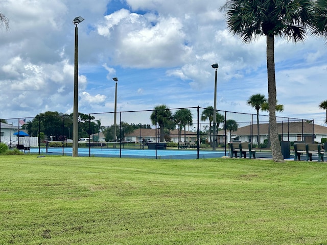 view of sport court with a yard