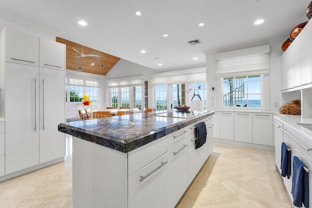 kitchen featuring visible vents, white cabinets, a center island, electric stovetop, and recessed lighting