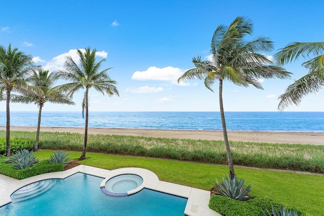 view of swimming pool featuring a water view, a view of the beach, a lawn, and an in ground hot tub