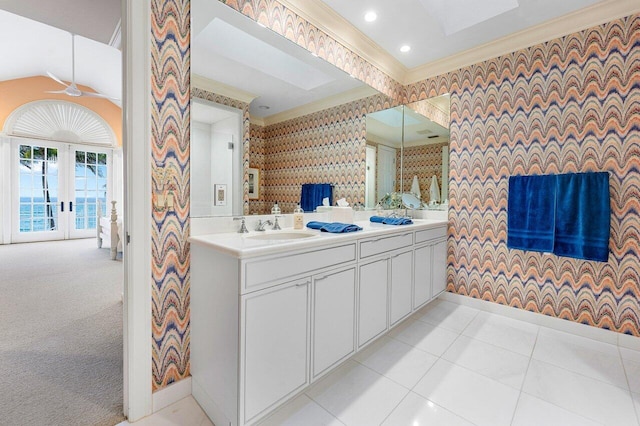 full bathroom with crown molding, baseboards, a sink, and wallpapered walls