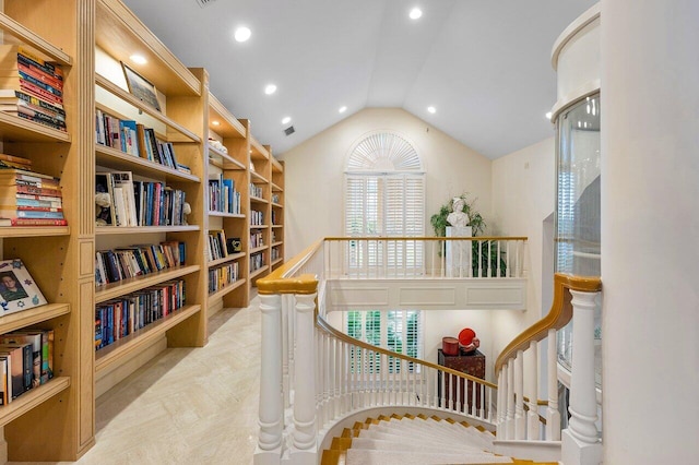 interior space featuring an upstairs landing, visible vents, vaulted ceiling, and recessed lighting