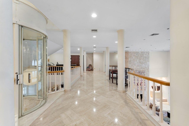 corridor featuring an upstairs landing, decorative columns, visible vents, and recessed lighting