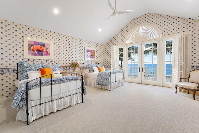 bedroom with access to exterior, french doors, carpet flooring, vaulted ceiling, and wallpapered walls