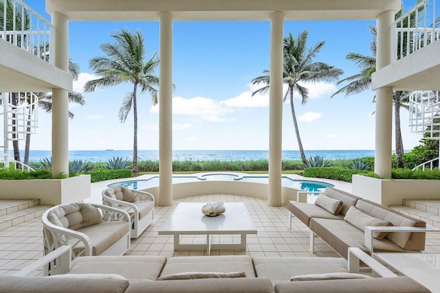 view of patio with stairs, outdoor lounge area, and a water view