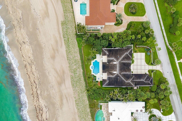 birds eye view of property featuring a view of the beach and a water view