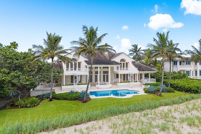 rear view of house featuring a patio, a balcony, an outdoor hangout area, a yard, and french doors