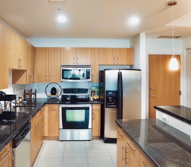 kitchen featuring tasteful backsplash, dark stone countertops, light tile patterned floors, pendant lighting, and stainless steel appliances