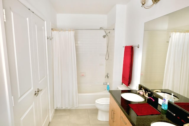 full bathroom featuring tile patterned floors, toilet, shower / bath combo with shower curtain, and vanity