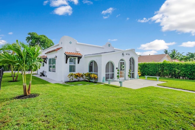 rear view of property featuring a lawn