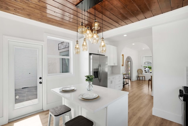 kitchen featuring white cabinetry, light hardwood / wood-style floors, wooden ceiling, and stainless steel refrigerator with ice dispenser