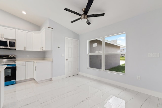 kitchen with white cabinets, appliances with stainless steel finishes, vaulted ceiling, and ceiling fan