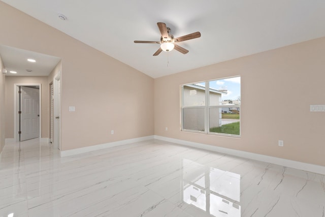 empty room with ceiling fan and vaulted ceiling