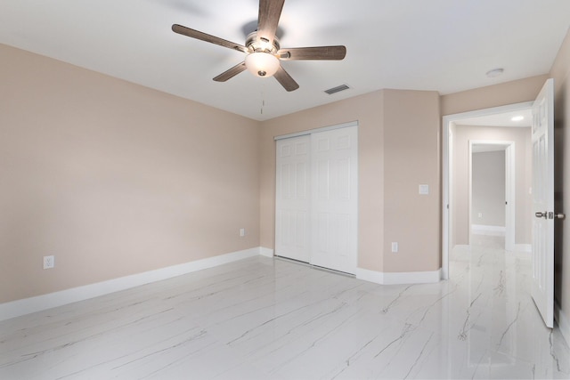 unfurnished bedroom featuring ceiling fan and a closet