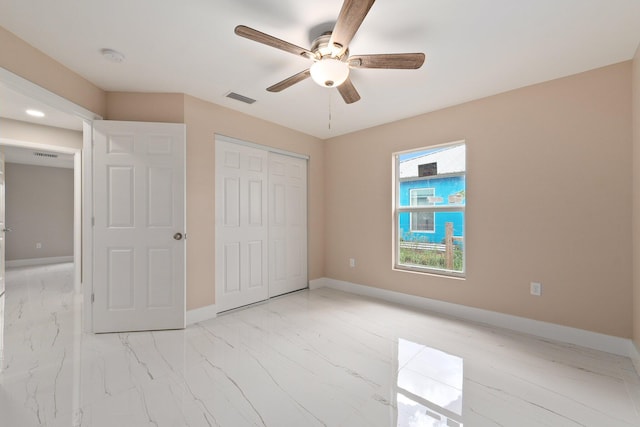 unfurnished bedroom with ceiling fan and a closet