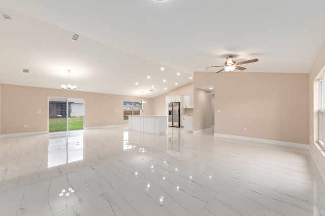 spare room featuring ceiling fan with notable chandelier and lofted ceiling