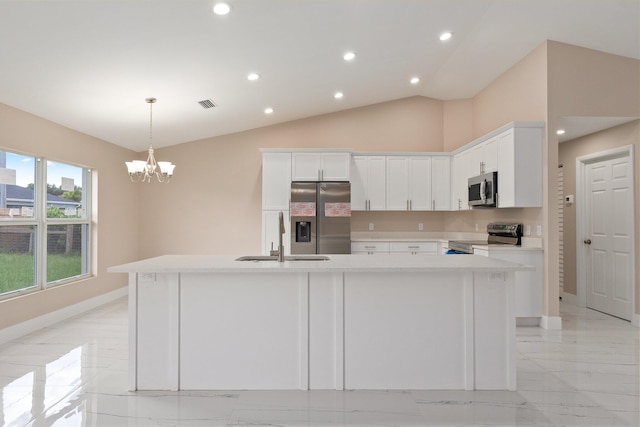 kitchen featuring a kitchen island with sink, a chandelier, stainless steel appliances, sink, and white cabinets