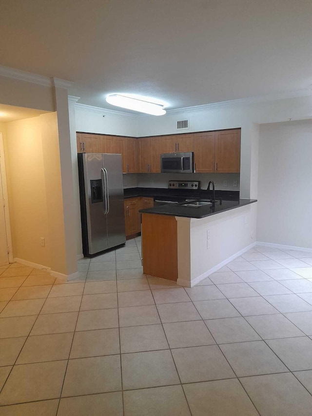 kitchen featuring crown molding, light tile patterned floors, stainless steel appliances, kitchen peninsula, and sink