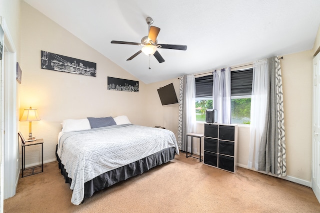 bedroom featuring ceiling fan, light carpet, and vaulted ceiling