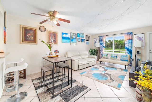 living room with ceiling fan and light tile patterned flooring