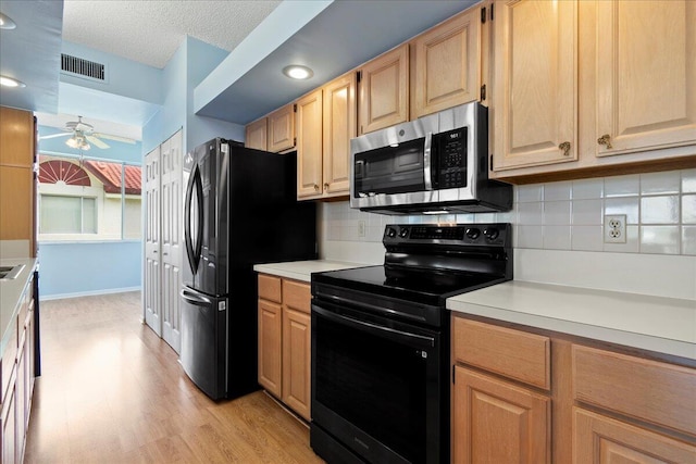 kitchen with tasteful backsplash, a textured ceiling, light wood-type flooring, ceiling fan, and black appliances