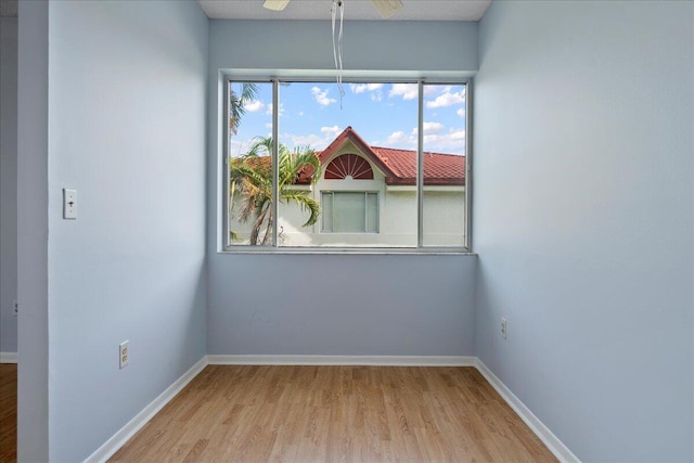 empty room featuring ceiling fan and light hardwood / wood-style floors