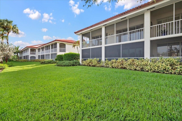 rear view of property with a lawn