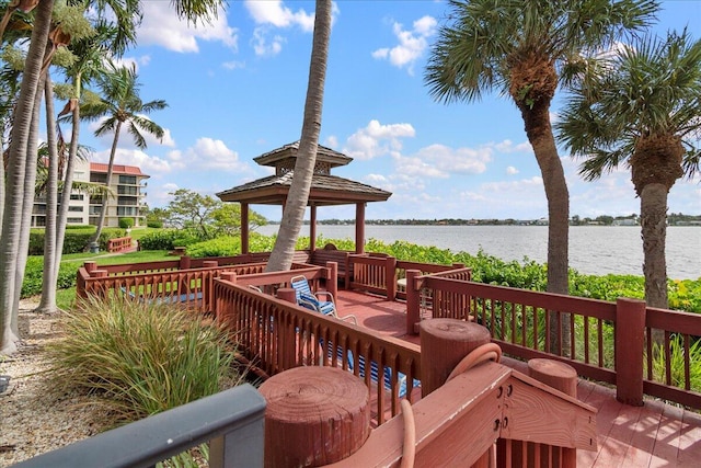 wooden deck with a water view and a gazebo