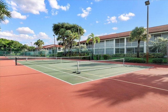 view of tennis court with basketball hoop