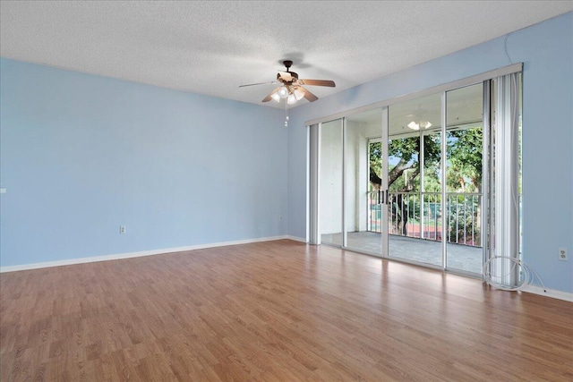 spare room with ceiling fan, hardwood / wood-style floors, and a textured ceiling