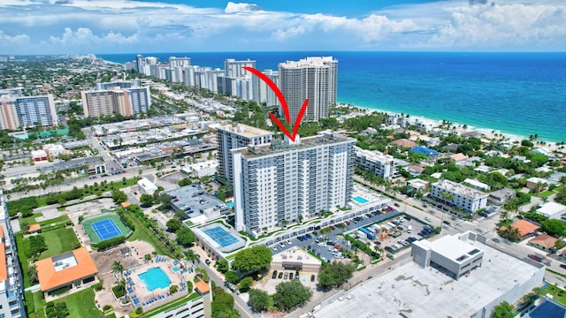 birds eye view of property with a beach view and a water view