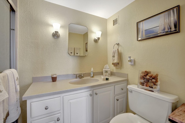 bathroom featuring toilet and vanity