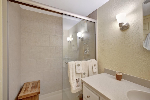 bathroom with an enclosed shower and vanity