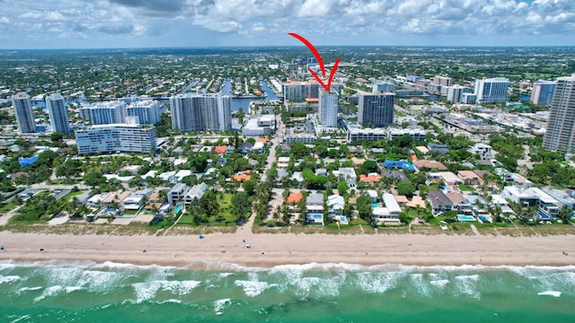 drone / aerial view featuring a view of the beach and a water view