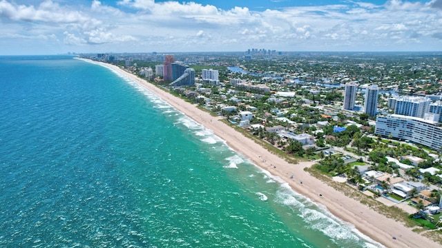 bird's eye view featuring a view of the beach and a water view