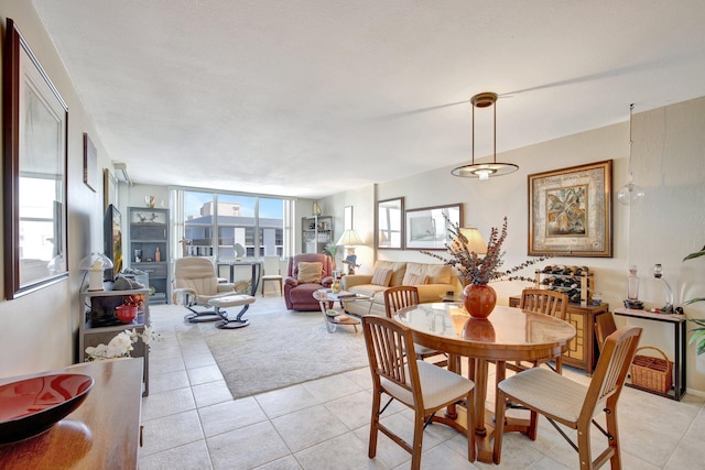 dining area featuring expansive windows and light tile patterned floors