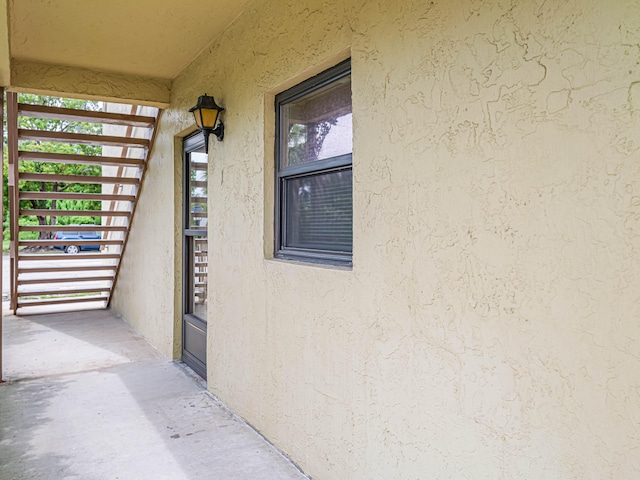 view of exterior entry with a balcony