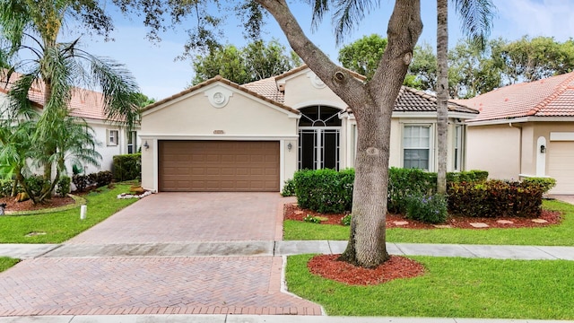 view of front of house with a front lawn and a garage