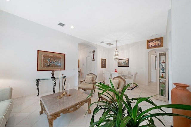 living room with a chandelier and light tile patterned floors