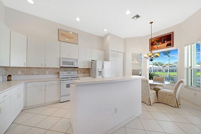 kitchen featuring white appliances, light tile patterned floors, visible vents, backsplash, and a notable chandelier